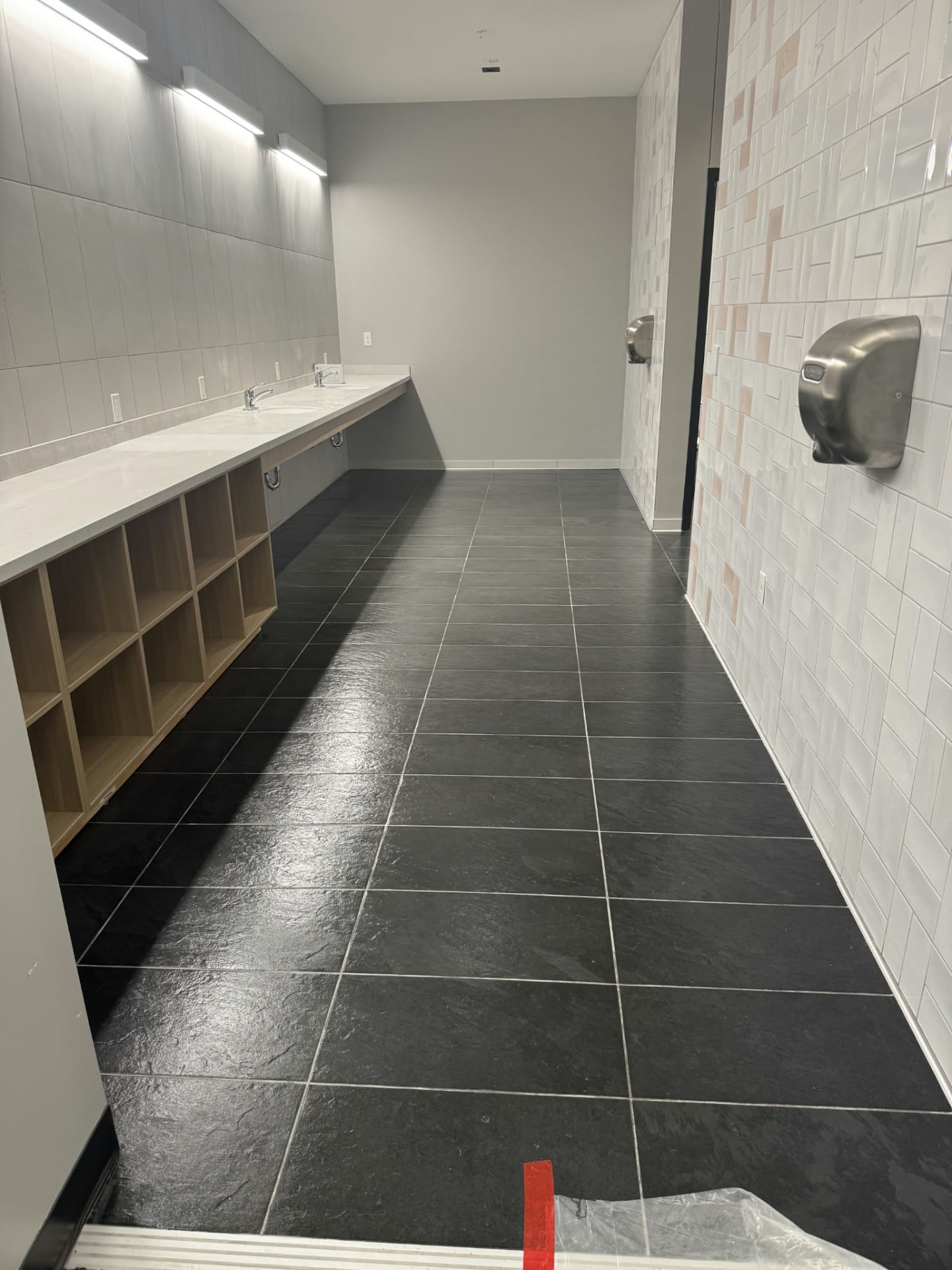 A gleaming commercial restroom with polished tile floor