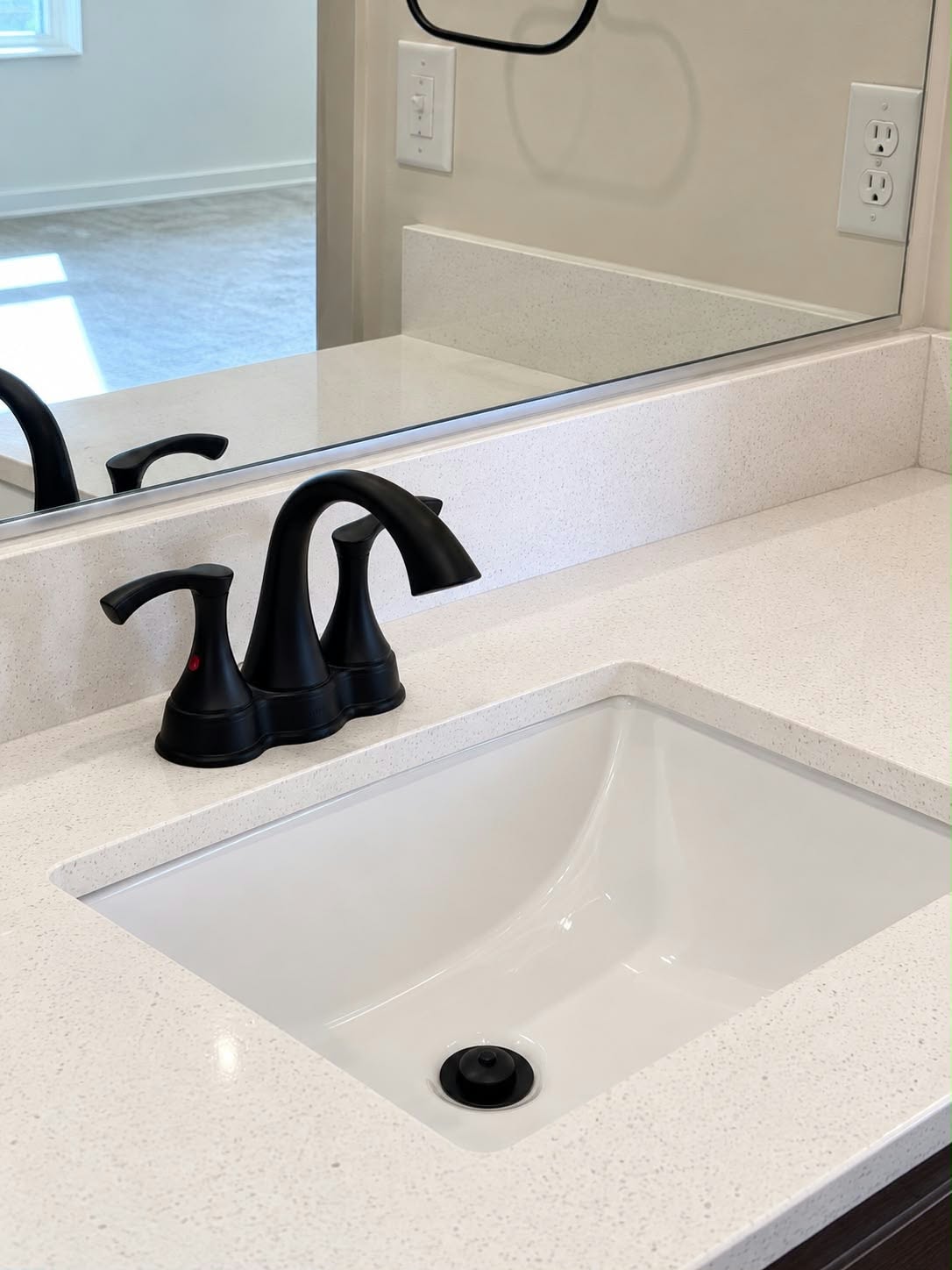 A polished bathroom sink and countertop after cleaning